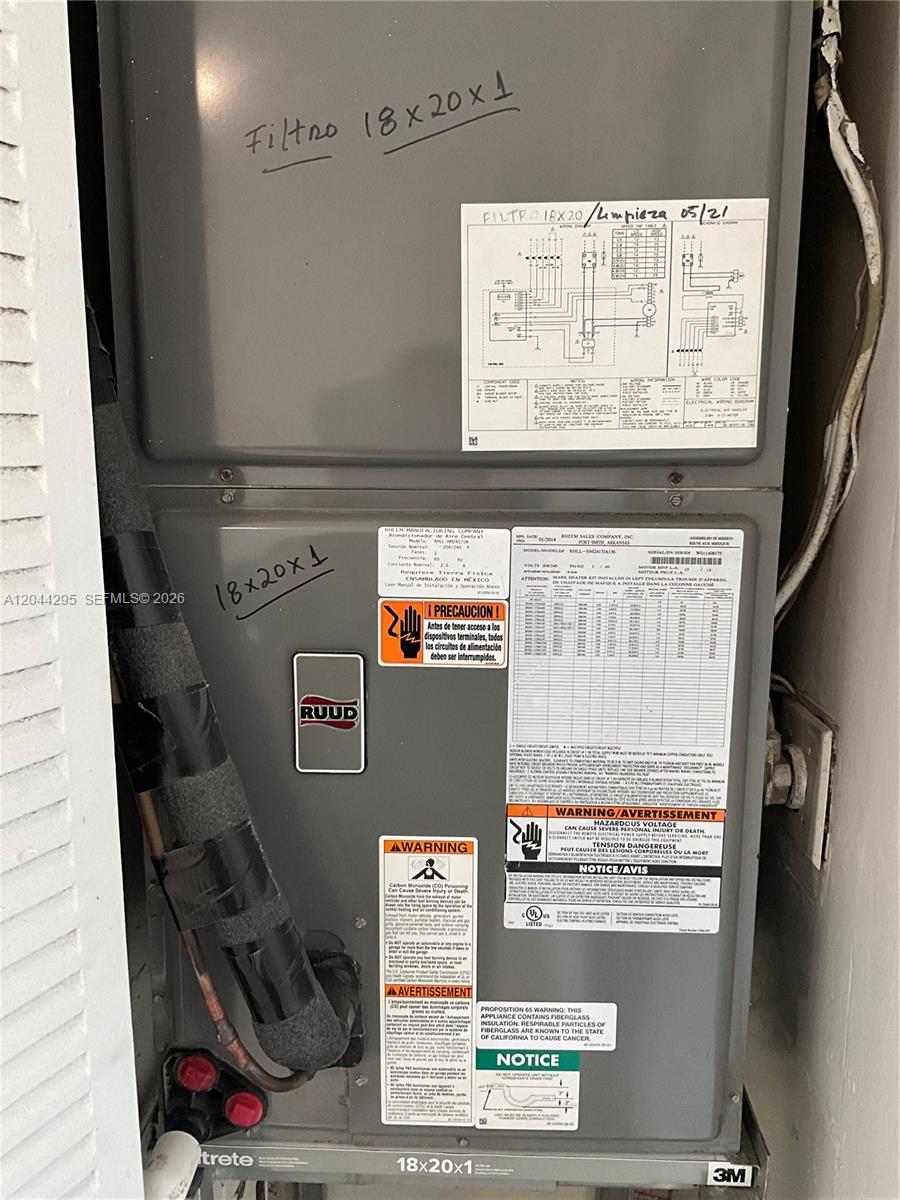 9441 Southwest 4th Street, Unit 214 Miami, FL 33174 - Photo 16 of 22 a view of water heater room with washer and dryer