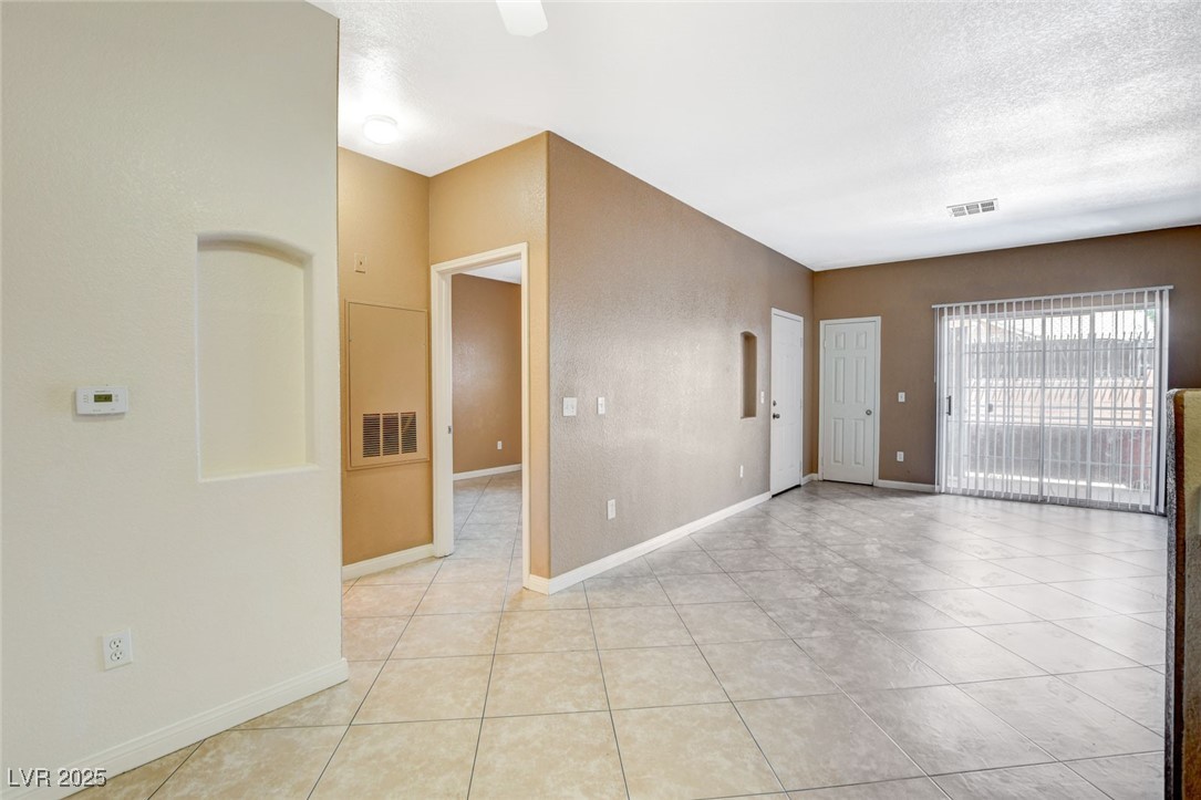 4730 East Craig Road, Unit 1005 Las Vegas, NV 89115 - Photo 11 of 45 Spare room featuring light tile patterned flooring and a textured ceiling