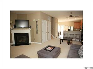 1035 Market Street, Unit 1035 Fort Mill, SC 29708 - Photo 5 of 16 a living room with furniture and a flat screen tv