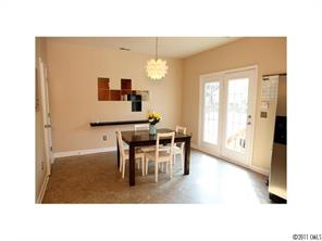 1035 Market Street, Unit 1035 Fort Mill, SC 29708 - Photo 9 of 16 a dining room with furniture and a chandelier