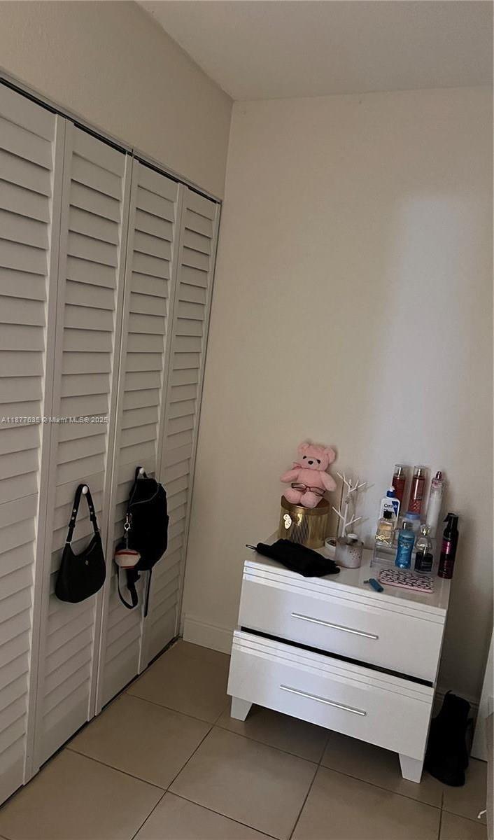 8875 Fontainebleau Boulevard, Unit 203 Miami, FL 33172 - Photo 11 of 22 a bedroom with furniture and a window