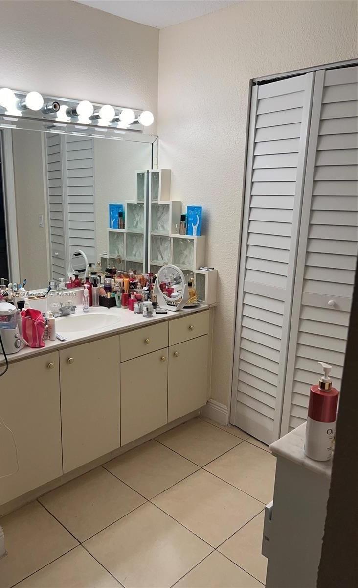 8875 Fontainebleau Boulevard, Unit 203 Miami, FL 33172 - Photo 13 of 22 a bathroom with a sink and a mirror