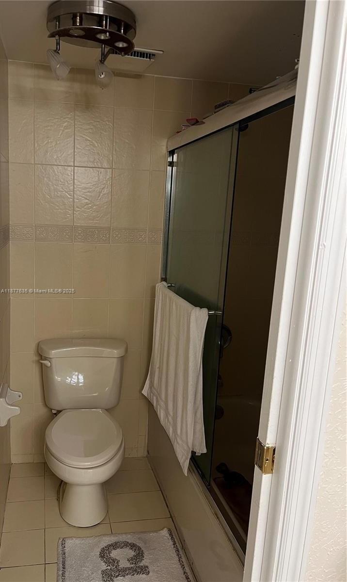 8875 Fontainebleau Boulevard, Unit 203 Miami, FL 33172 - Photo 14 of 22 a bathroom with a toilet and a shower