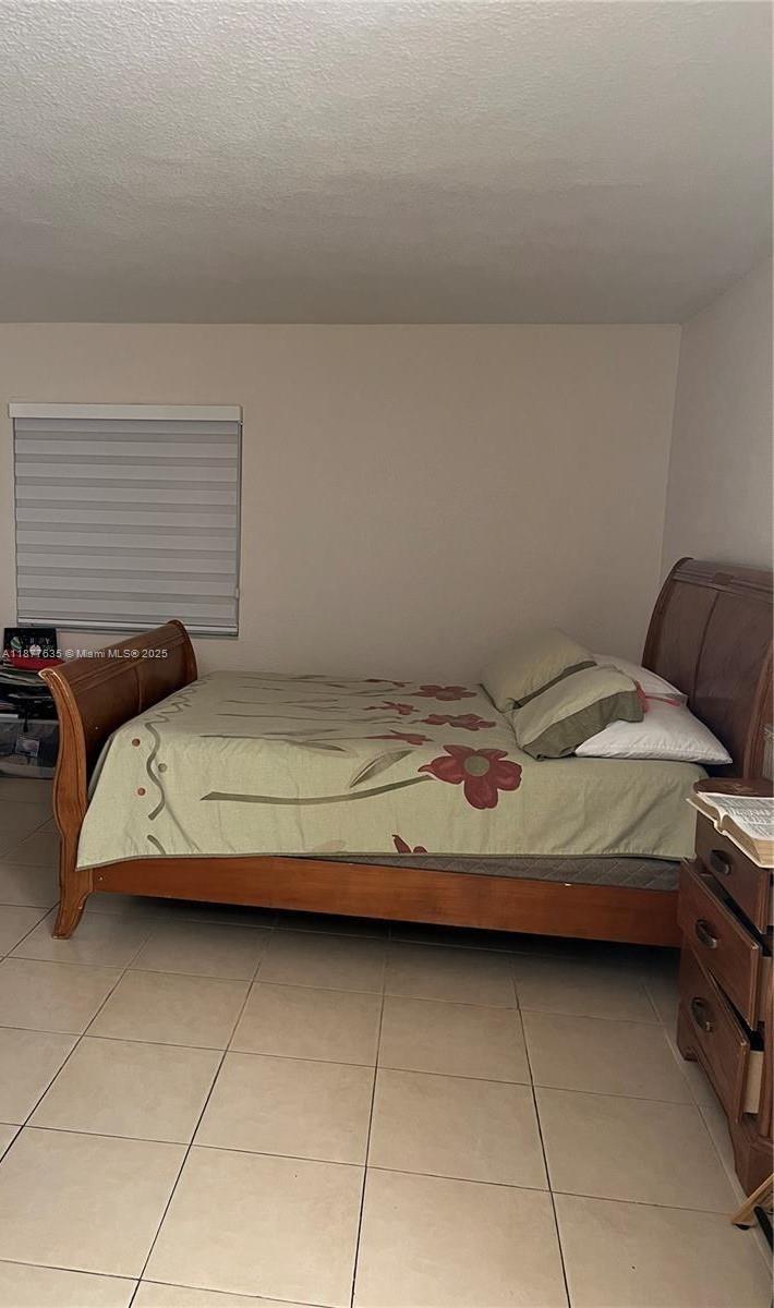 8875 Fontainebleau Boulevard, Unit 203 Miami, FL 33172 - Photo 15 of 22 a bedroom with a bed and a table