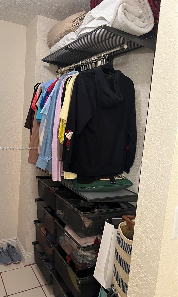 8875 Fontainebleau Boulevard, Unit 203 Miami, FL 33172 - Photo 16 of 22 a view of walk in closet with clothes