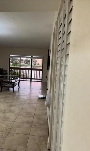 a lobby with furniture and floor to ceiling window