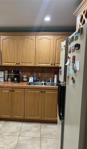 a room with stainless steel appliances granite countertop a refrigerator and a stove