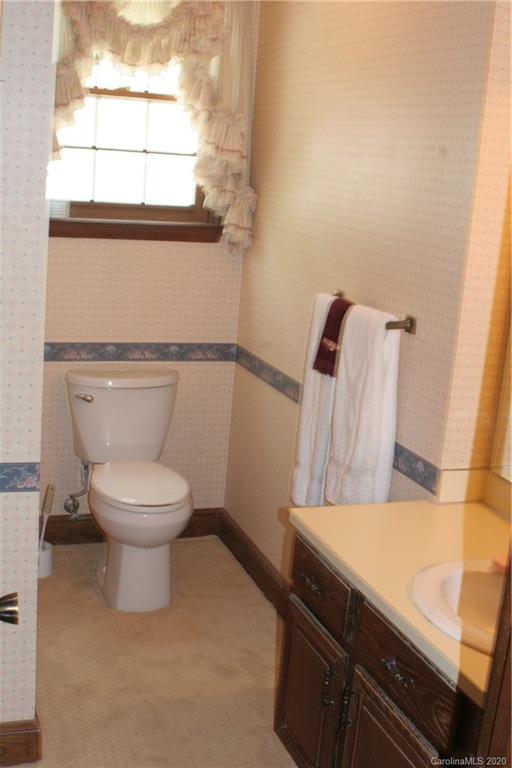 1160 Ben Black Road Midland, NC 28107 - Photo 11 of 28 a bathroom with a toilet a sink and a window