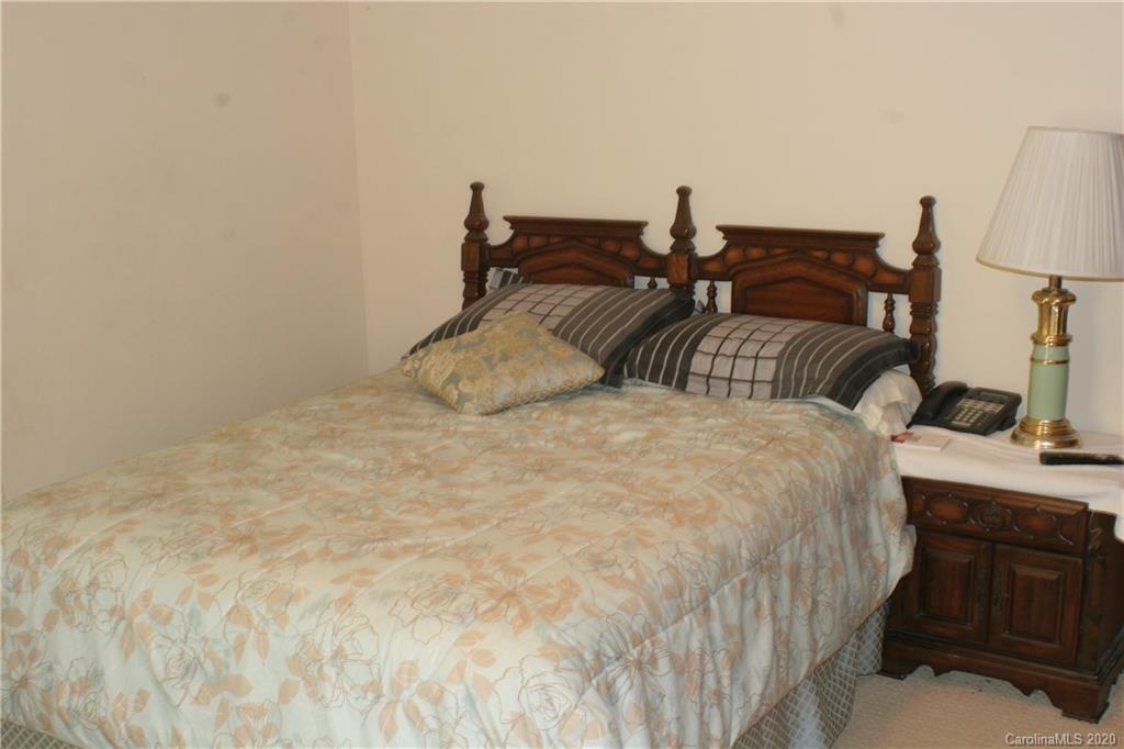 1160 Ben Black Road Midland, NC 28107 - Photo 14 of 28 a bedroom with a bed and a lamp on dresser