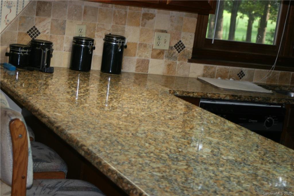 1160 Ben Black Road Midland, NC 28107 - Photo 16 of 28 a bathroom with a granite countertop sink and a mirror