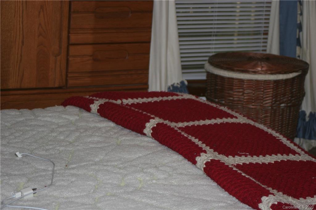 1160 Ben Black Road Midland, NC 28107 - Photo 19 of 28 a bedroom with a bed and a chair