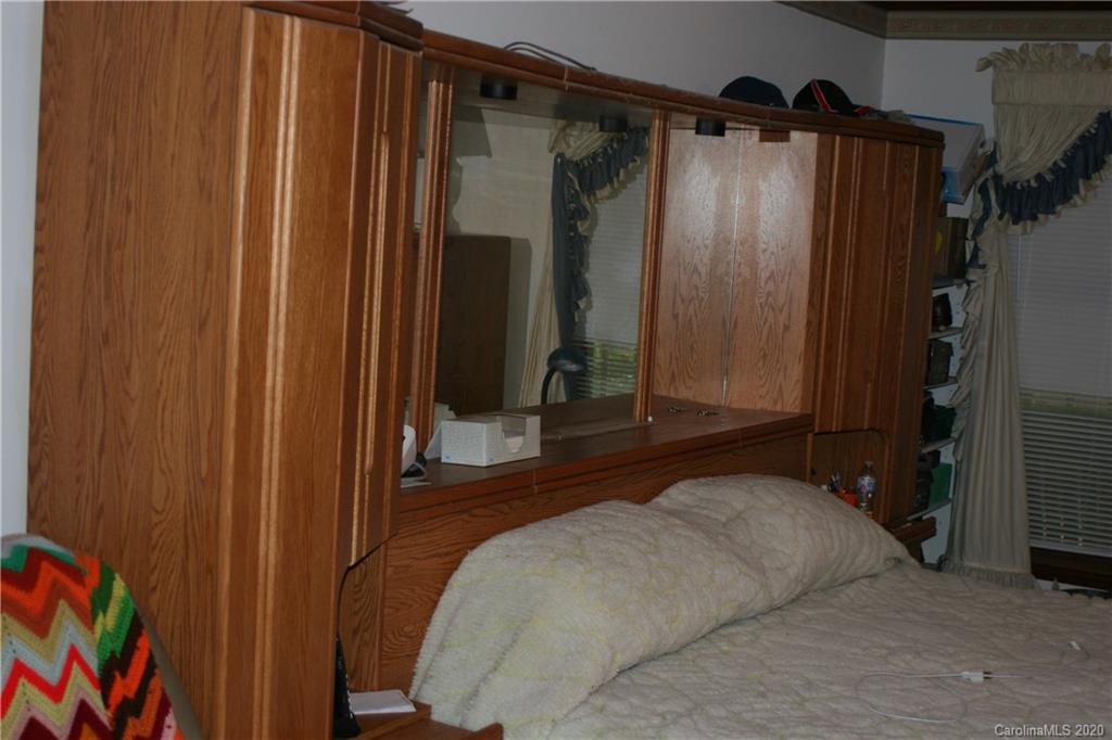 1160 Ben Black Road Midland, NC 28107 - Photo 20 of 28 a bedroom with a bed and a mirror