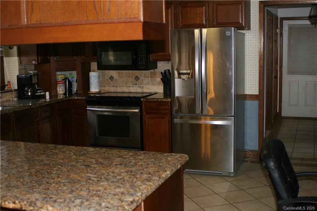 1160 Ben Black Road Midland, NC 28107 - Photo 26 of 28 a kitchen with a refrigerator and a stove