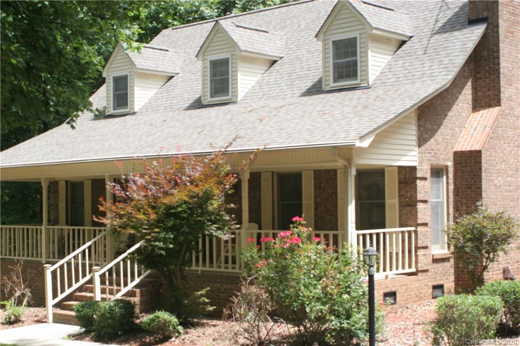 1160 Ben Black Road Midland, NC 28107 - Photo 5 of 28 a view of a white house with large windows and flower plants