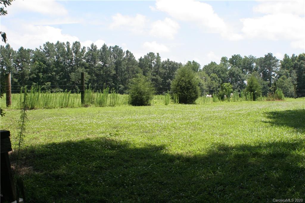 1160 Ben Black Road Midland, NC 28107 - Photo 10 of 28 a view of a grassy field with trees in the background