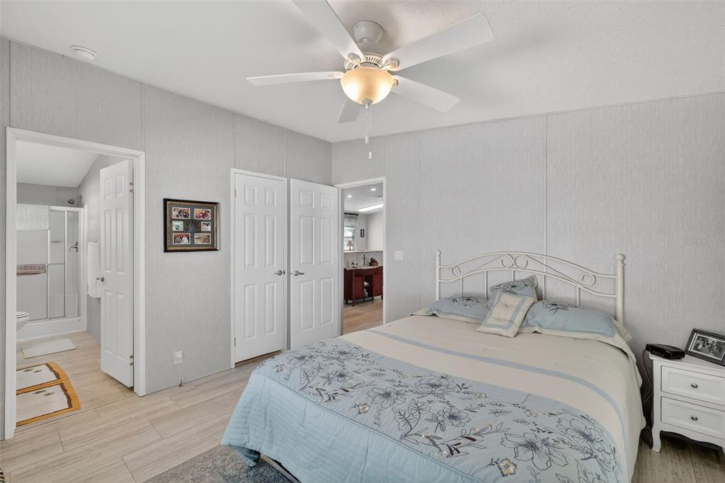 11523 Marvell Way Leesburg, FL 34788 - Photo 16 of 40 a bedroom with a bed and a chandelier