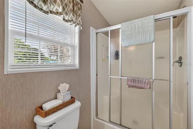 a bathroom with a window and shower
