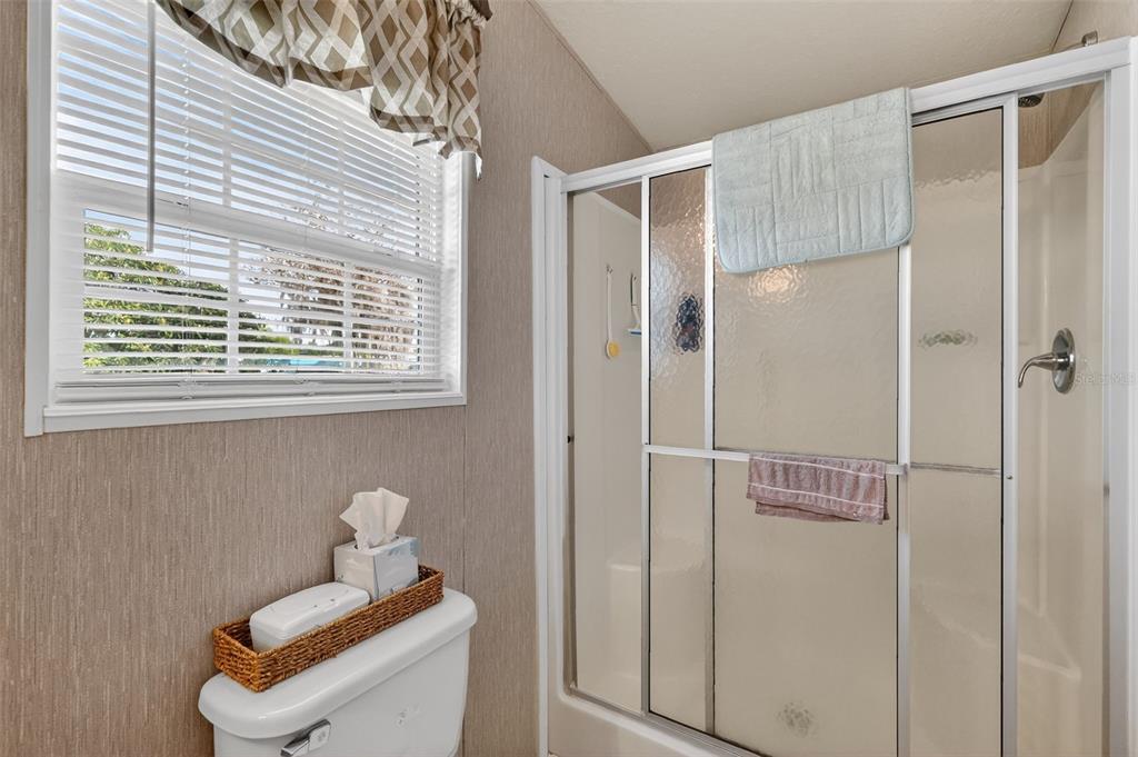 11523 Marvell Way Leesburg, FL 34788 - Photo 18 of 40 a bathroom with a window and shower