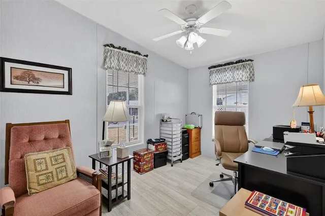a reading room with furniture a chandelier and a window