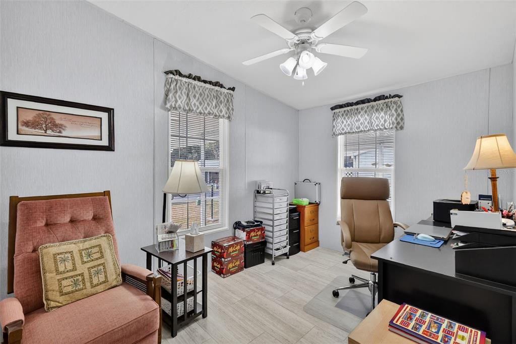 11523 Marvell Way Leesburg, FL 34788 - Photo 20 of 40 a reading room with furniture a chandelier and a window