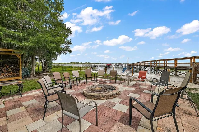 a view of a chairs and table in backyard of the house