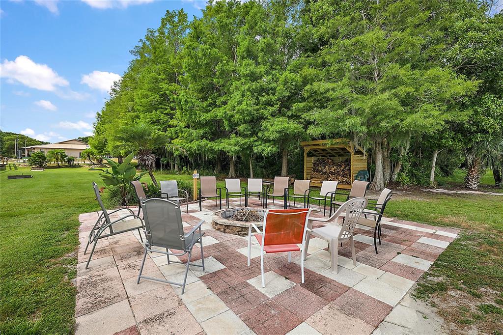 11523 Marvell Way Leesburg, FL 34788 - Photo 35 of 40 a view of a chairs and table in backyard of the house