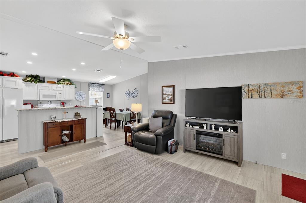11523 Marvell Way Leesburg, FL 34788 - Photo 4 of 40 a living room with furniture and a flat screen tv