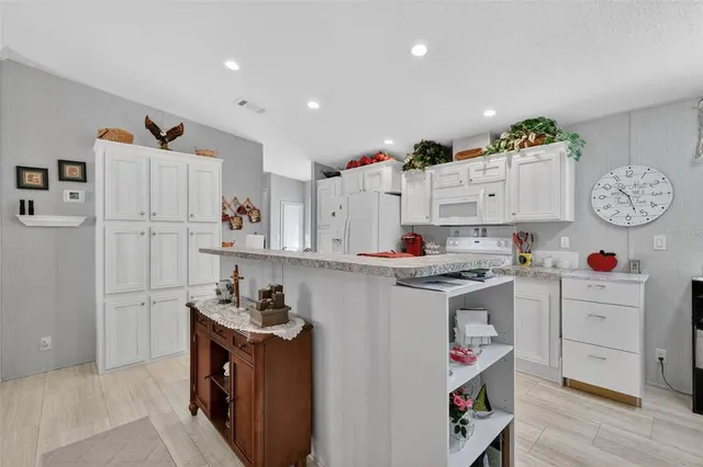 a kitchen with a white stove top oven and cabinets