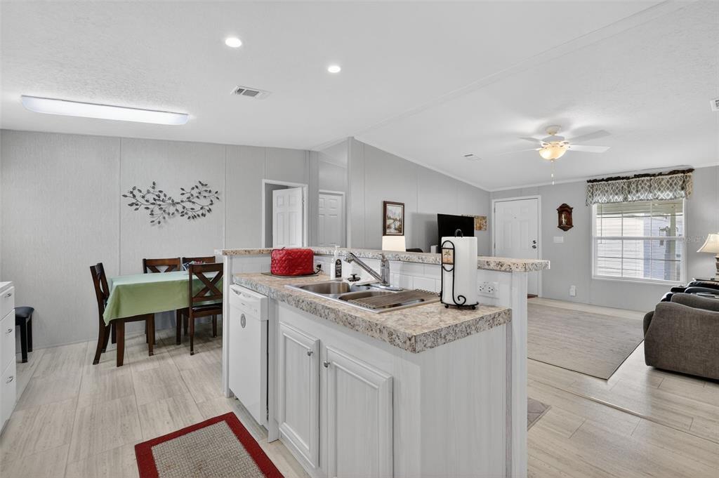 11523 Marvell Way Leesburg, FL 34788 - Photo 8 of 40 a living room with granite countertop furniture and wooden floor