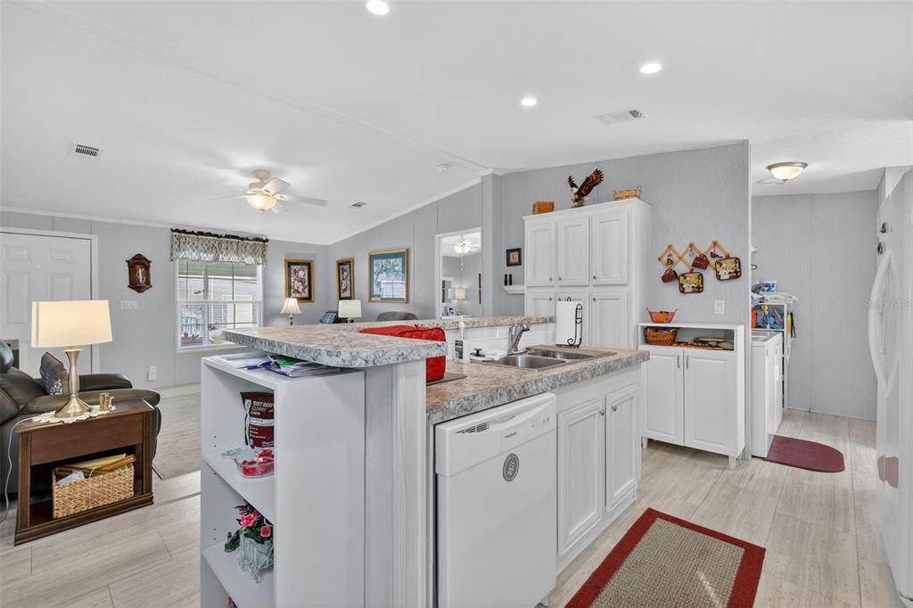 11523 Marvell Way Leesburg, FL 34788 - Photo 10 of 40 a kitchen with a sink stove and cabinets