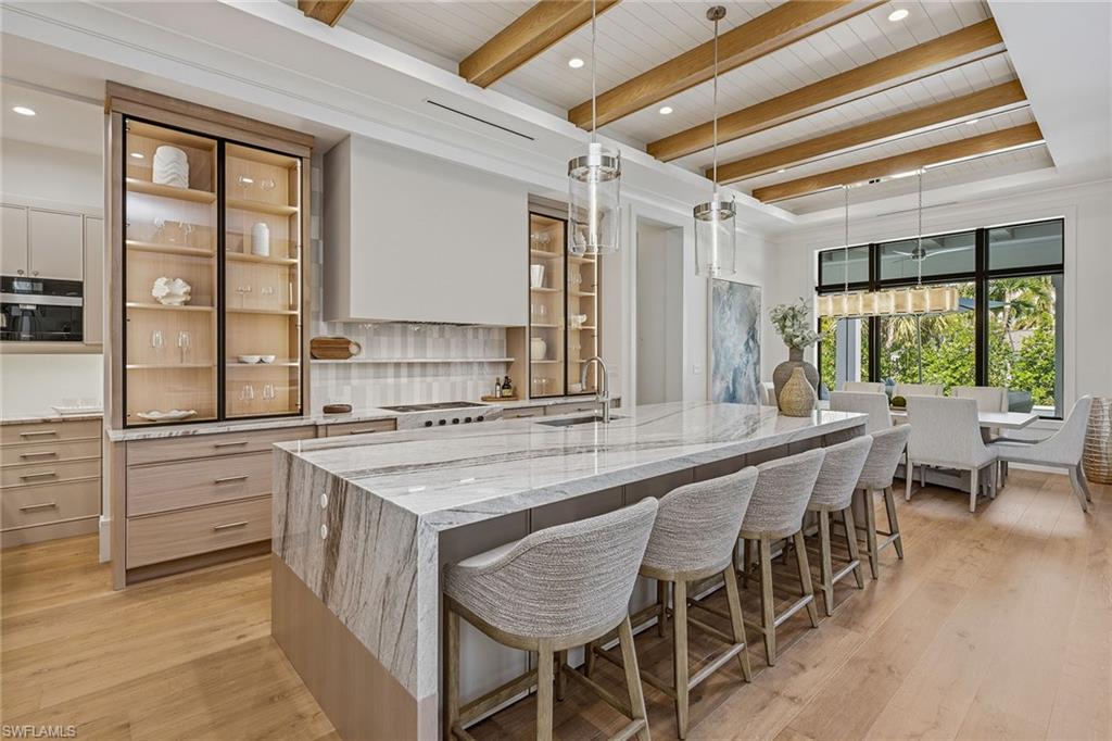 529 Neapolitan Way Naples, FL 34103 - Photo 6 of 26 a kitchen with a table and chairs in it
