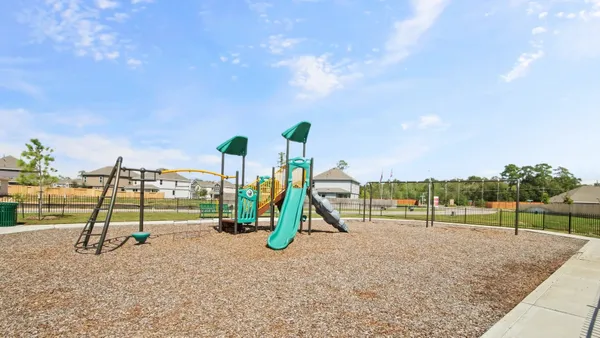a view of outdoor space with playground and green space