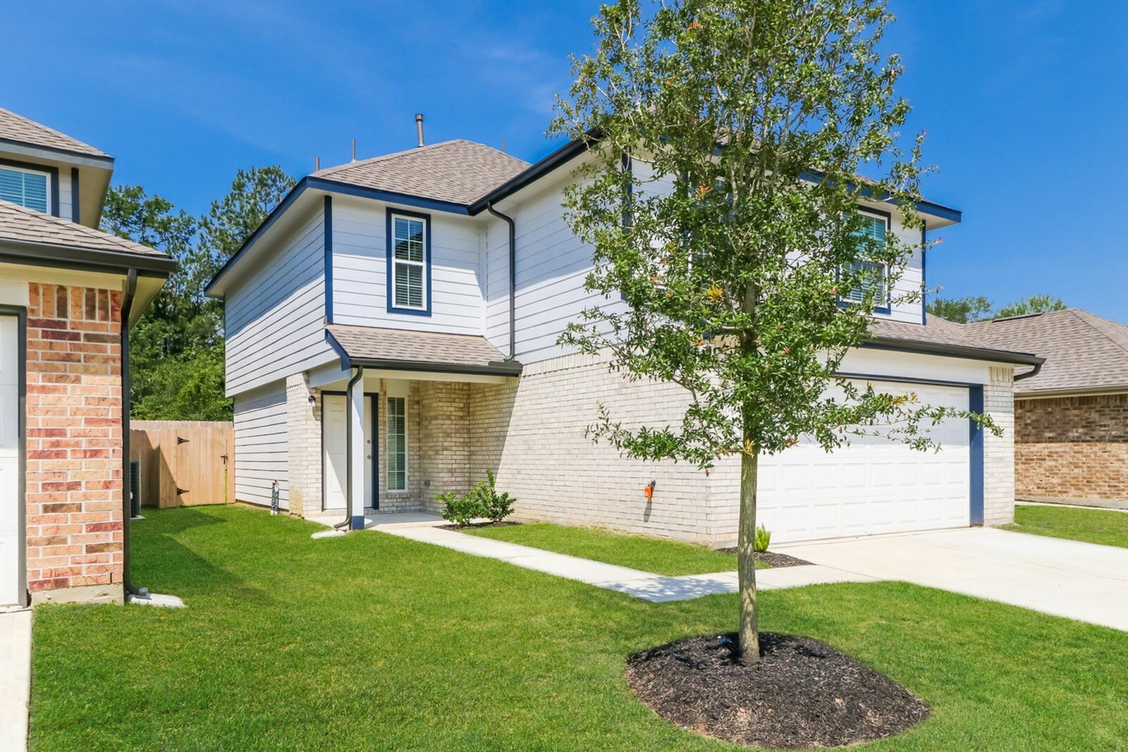 1128 Copal Trail Conroe, TX 77301 - Photo 2 of 22 a front view of a house with garden