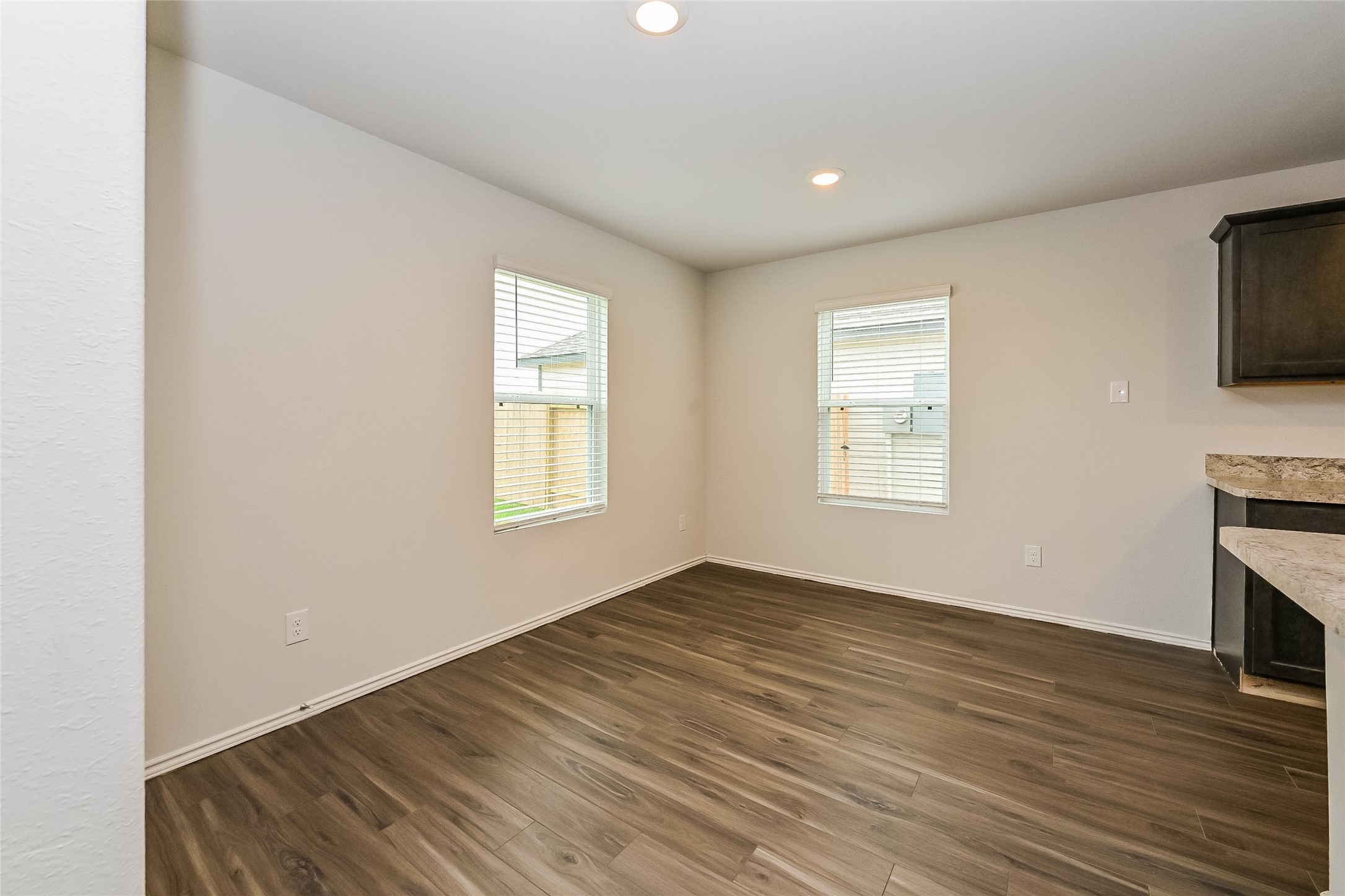 1128 Copal Trail Conroe, TX 77301 - Photo 7 of 22 wooden floor in an empty room with a window