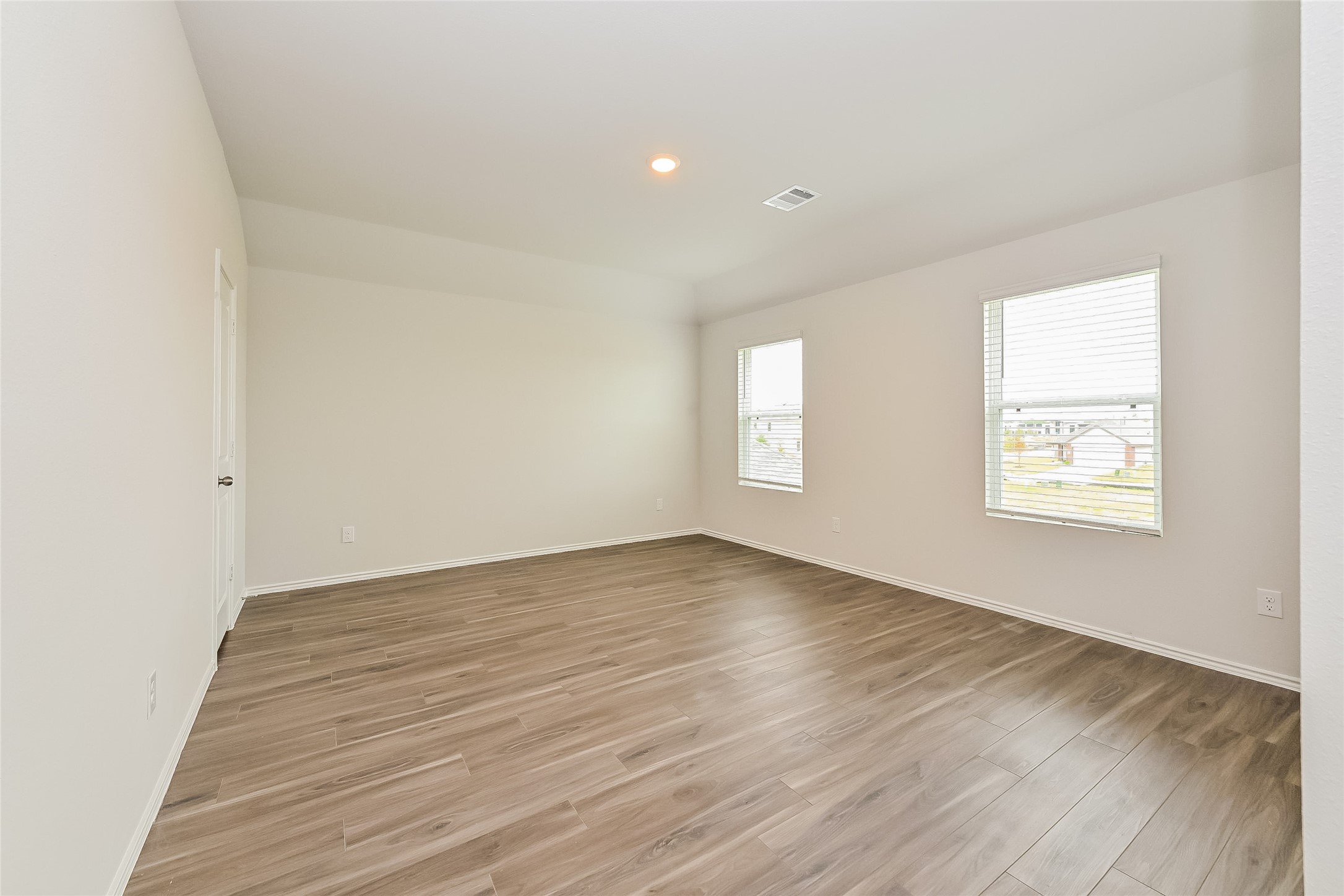 1128 Copal Trail Conroe, TX 77301 - Photo 10 of 22 an empty room with wooden floor and windows