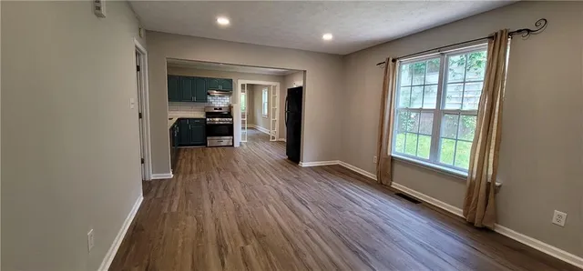 a view of a hallway view with wooden floor and furniture