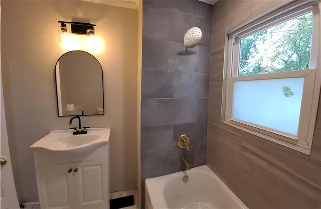 a bathroom with a sink mirror and toilet