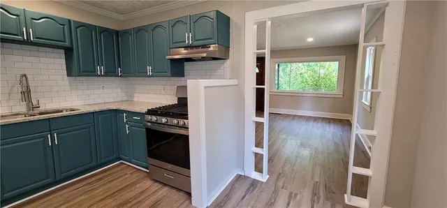 a kitchen with stainless steel appliances granite countertop a refrigerator and a sink