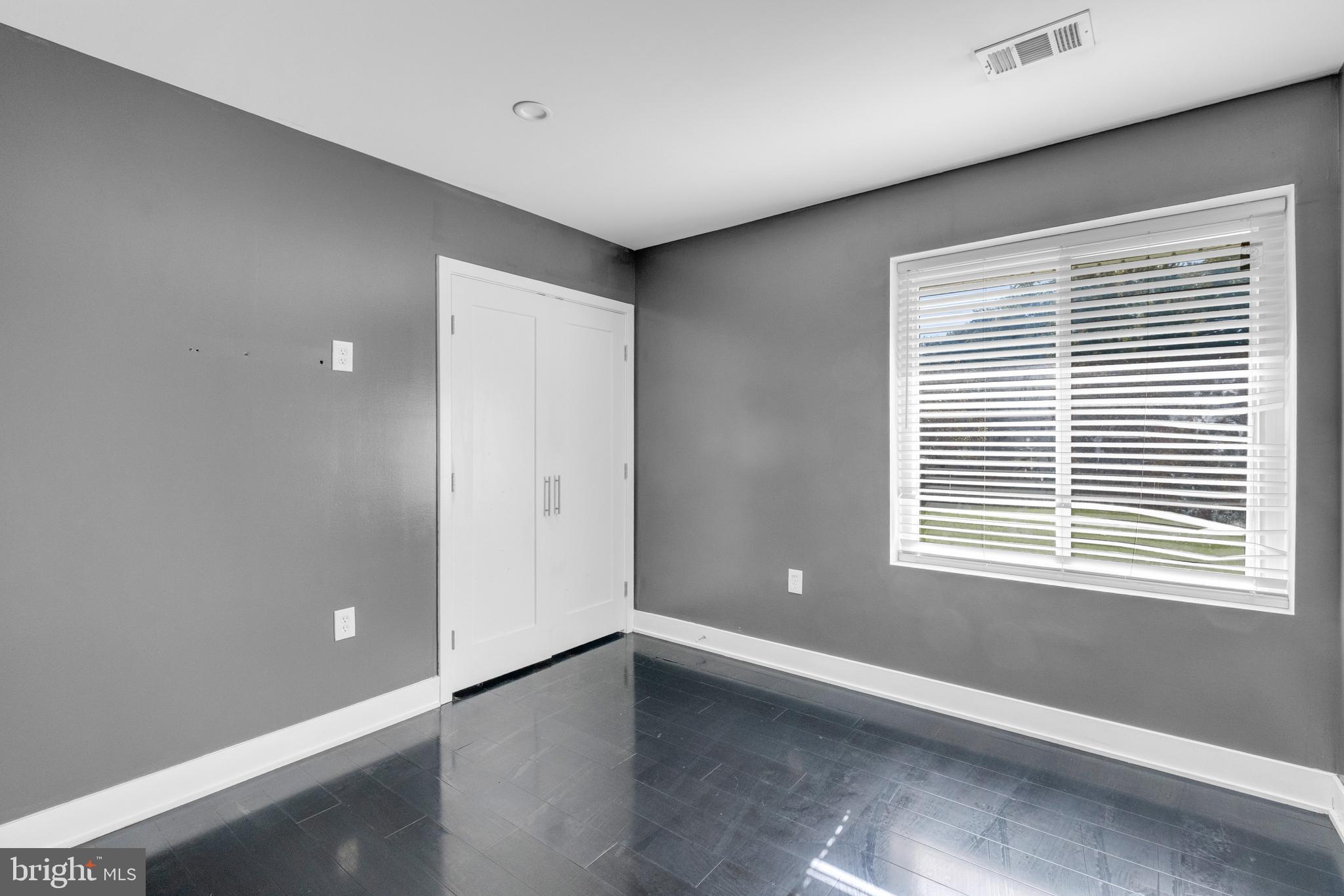 7600 Normandy Road Landover, MD 20785 - Photo 15 of 26 a view of an empty room with wooden floor and a window