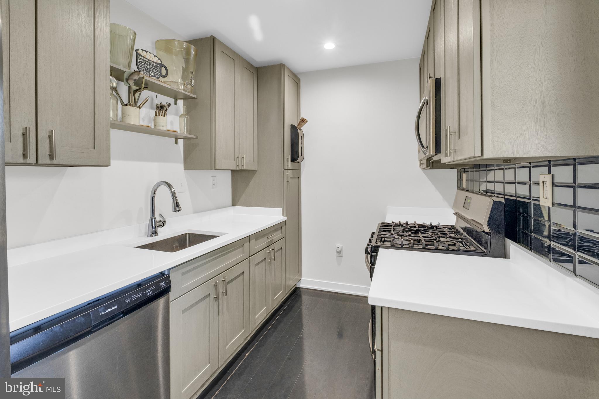 7600 Normandy Road Landover, MD 20785 - Photo 7 of 26 a kitchen with a sink a stove and cabinets