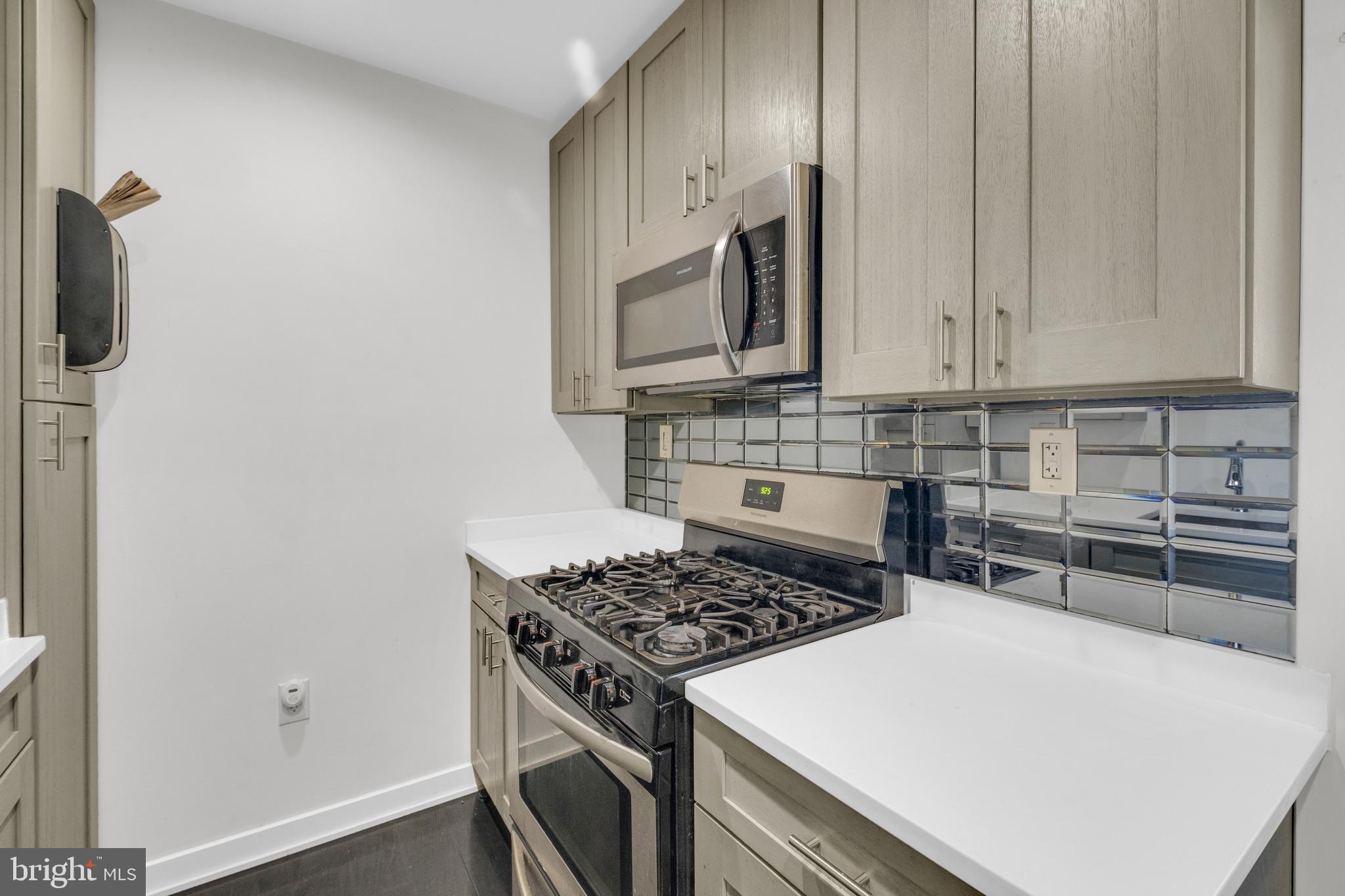 7600 Normandy Road Landover, MD 20785 - Photo 8 of 26 a kitchen with a stove and a microwave