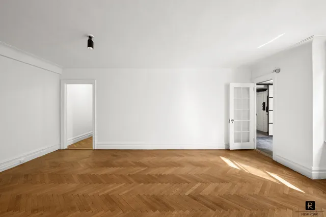 a view of an empty room with a closet