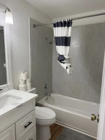 a living room with furniture and a painting on the wall