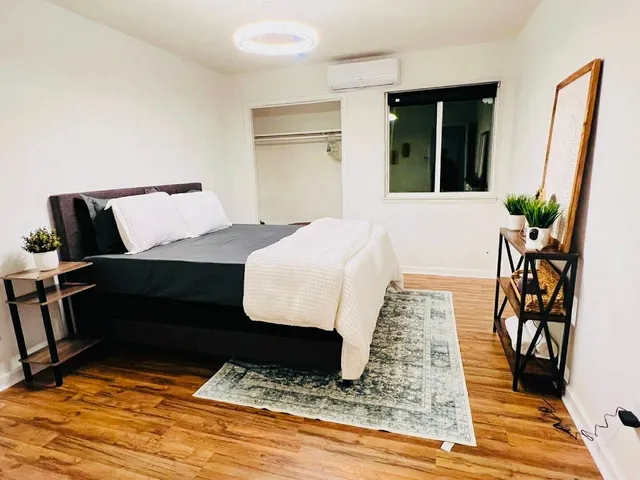 a bedroom with a bed and a window