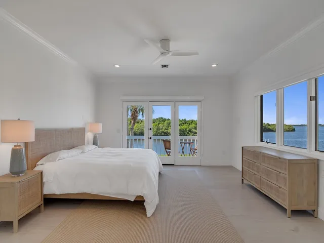 a bedroom with a large bed and a large window