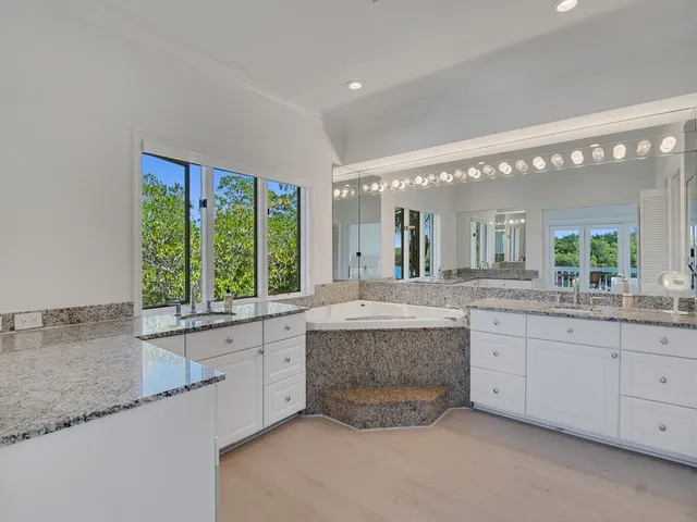 a large bathroom with a large window and double vanity