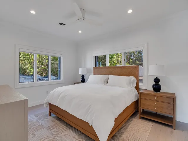a large bed sitting in a bedroom next to a window