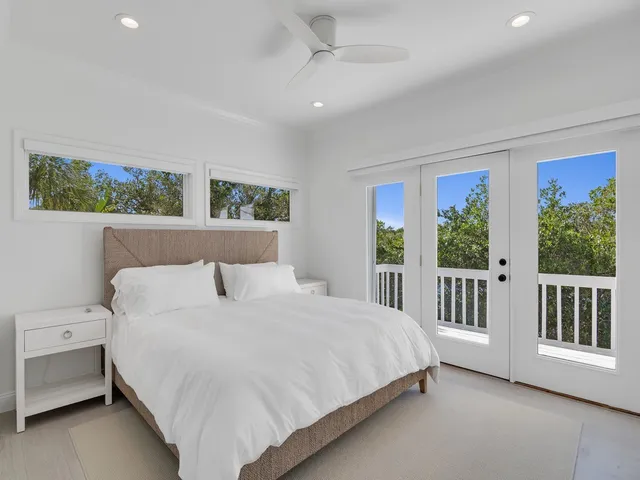 a bedroom with a large bed and a large window