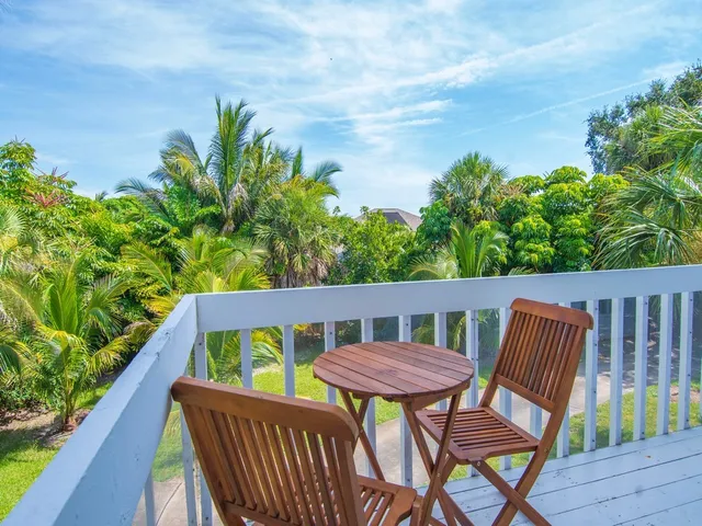a view of a chair and table in the balcony