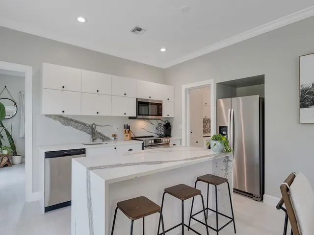 a kitchen with a sink cabinets and stainless steel appliances